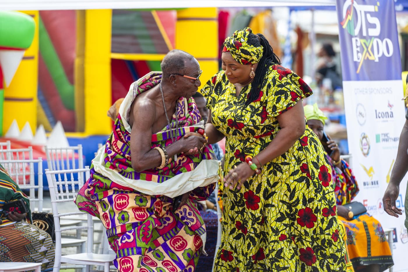 Visitors gathering around a stall selling local food produce
