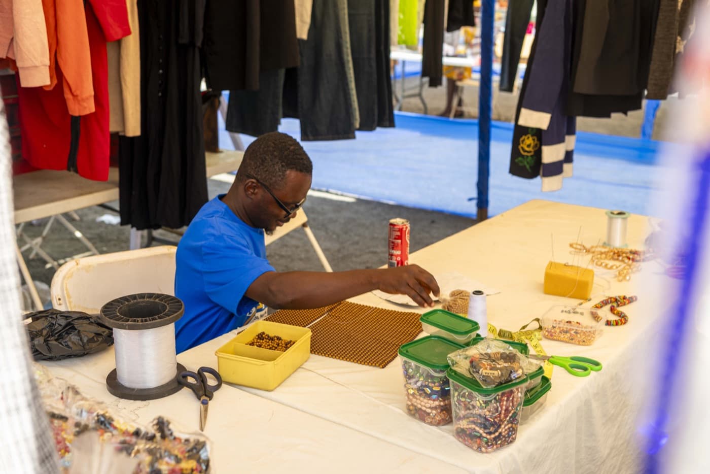 Artisan crafting beaded jewellery at his stall