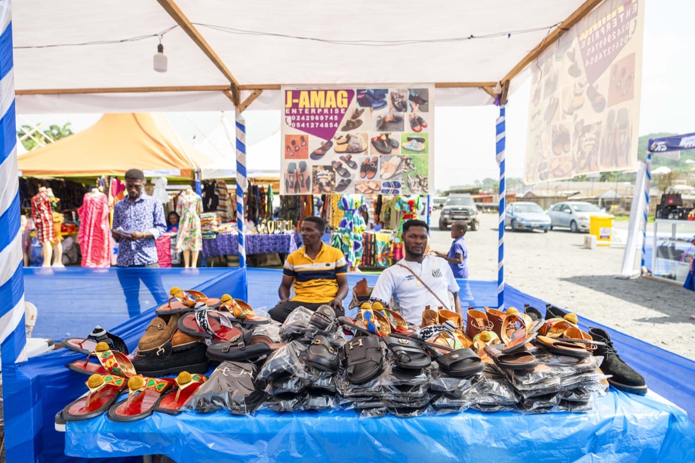 Footwear and slippers on an exhibitor's table under the OTS tents