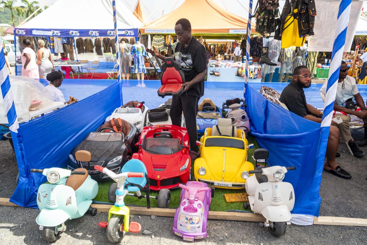 Children's ride-on cars and scooters on the exhibitors' lawn