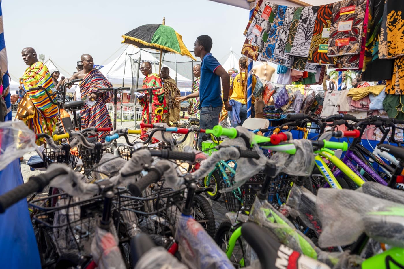 The traditional procession passes a bicycle exhibitor