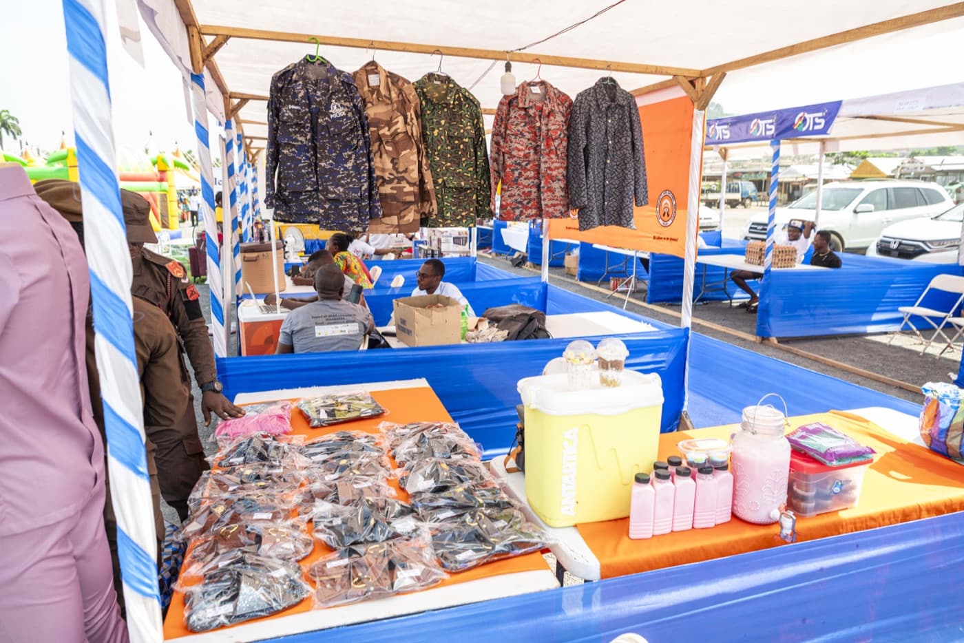 Garments, cosmetics and refreshments on an exhibitor's table