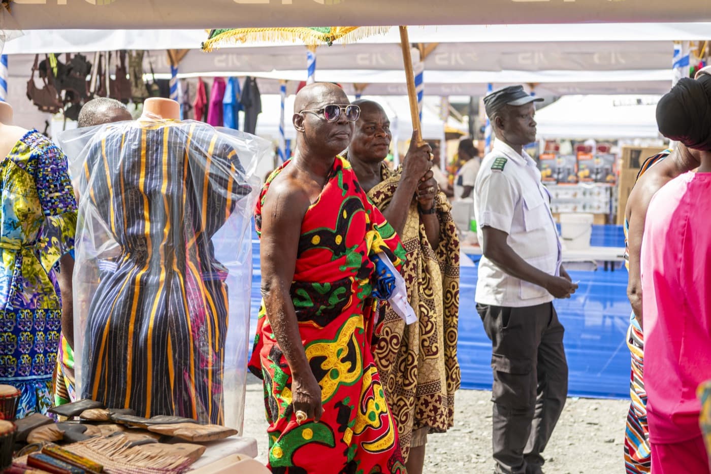 Chiefs in traditional regalia tour an exhibitor's stall